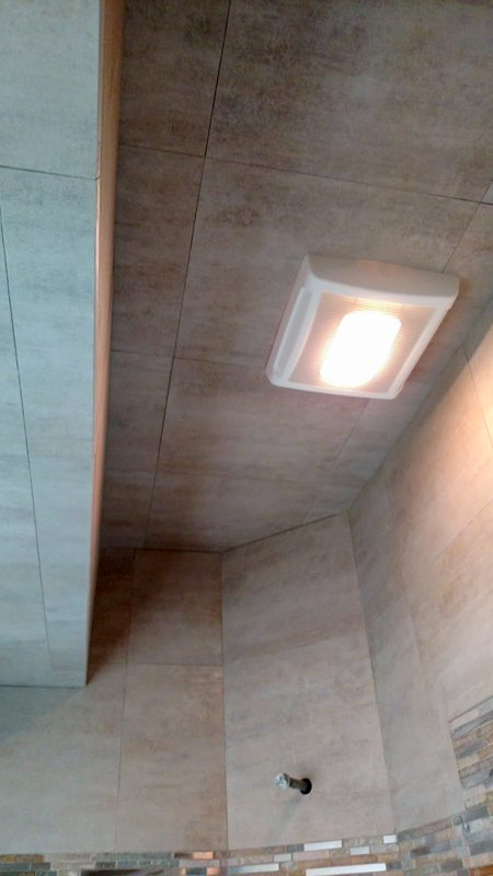 Tile bathroom with light fixture
