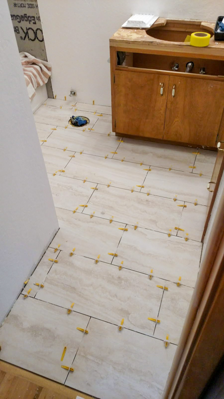 Floor tile installation in progress